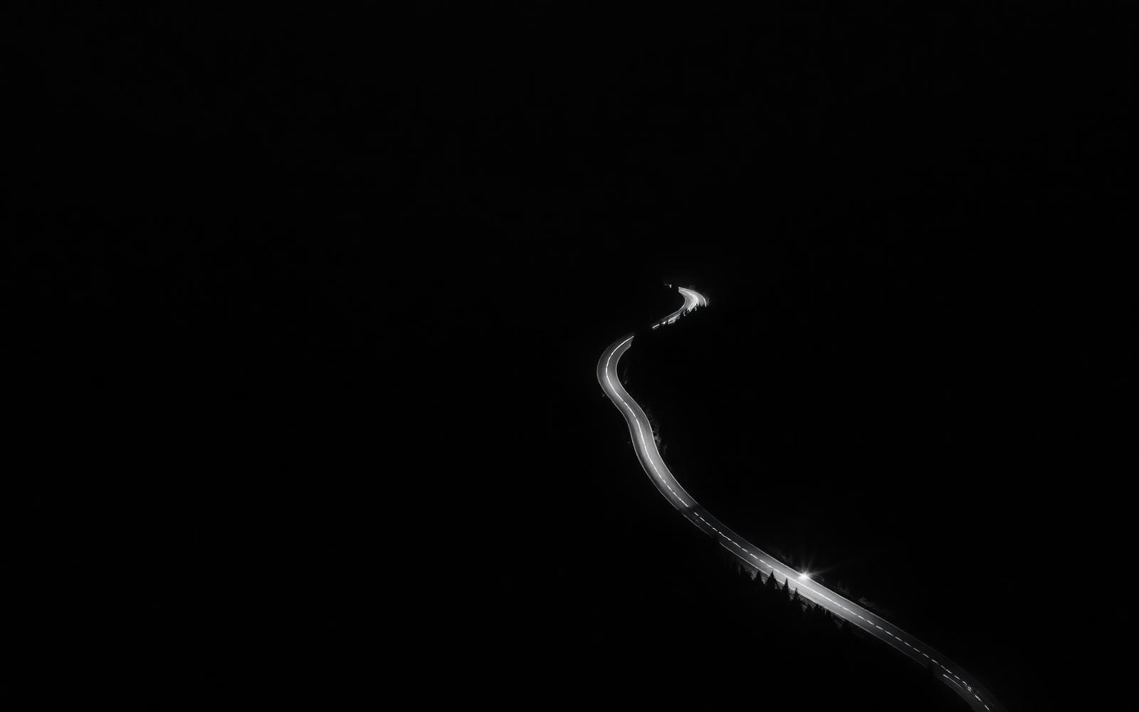 Aerial view of a winding mountain pass at night